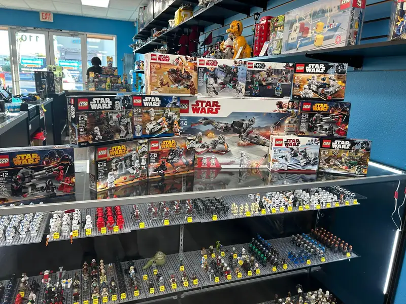 Boxed LEGO® Star Wars sets displayed above shelves of minifigures.