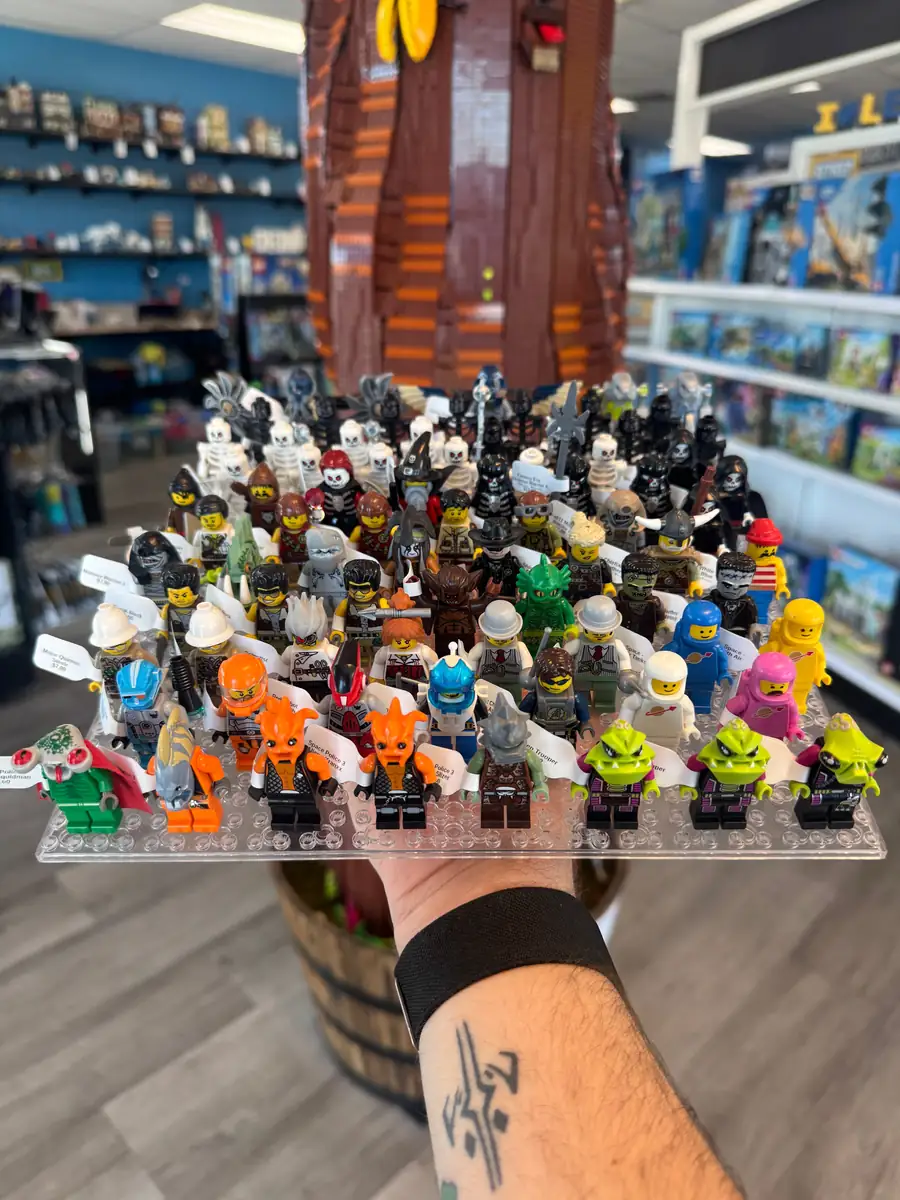 Rows of LEGO® minifigures on a hand-held display board at the Henderson store.