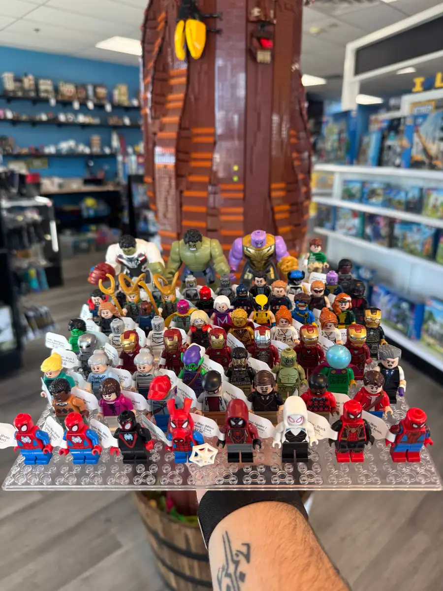 Rows of LEGO® minifigures on a hand-held display board at the Henderson store.
