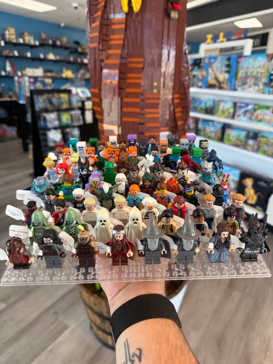 Rows of LEGO® minifigures on a hand-held display board at the Henderson store.