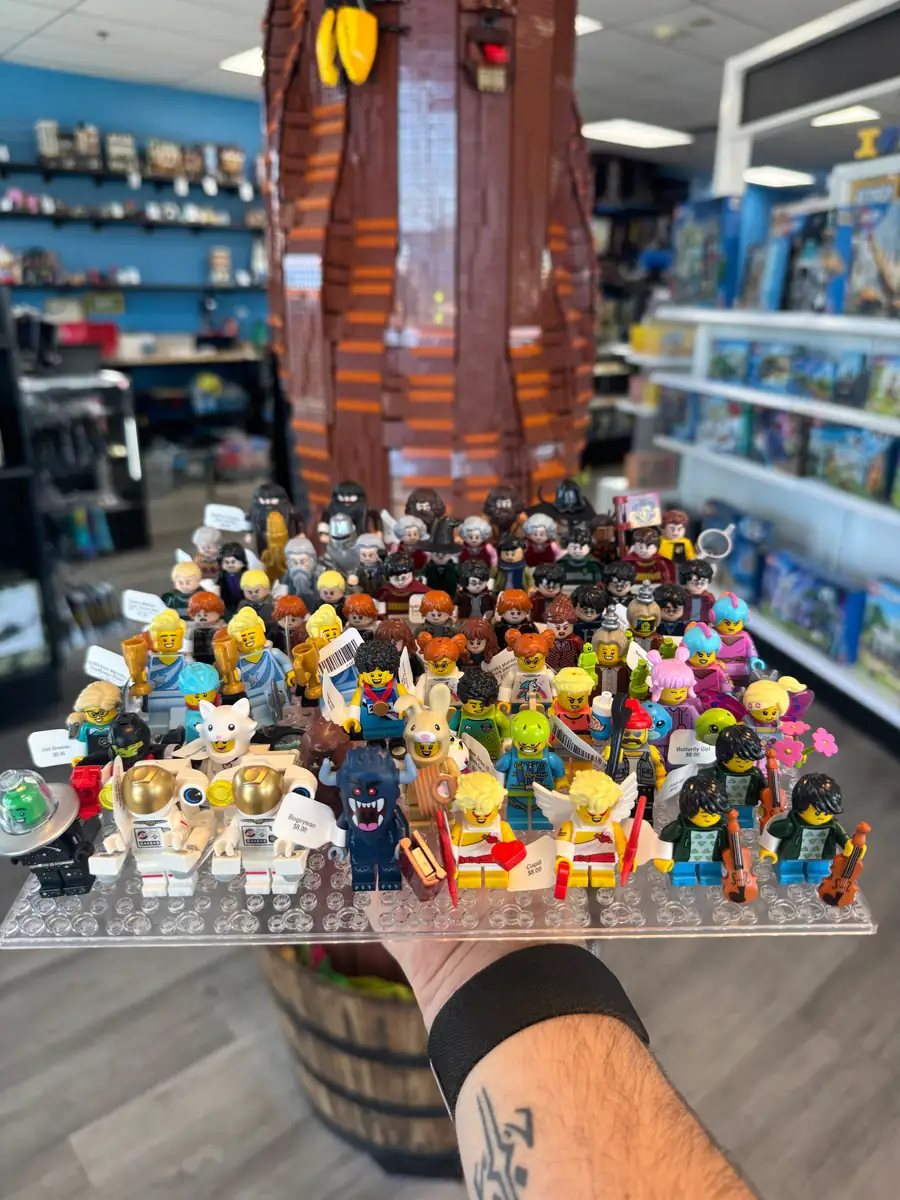 Rows of LEGO® minifigures on a hand-held display board at the Henderson store.