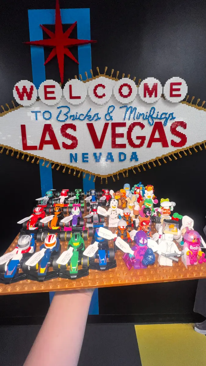 An assortment of LEGO® minifigures on a display board beneath the Las Vegas store sign.