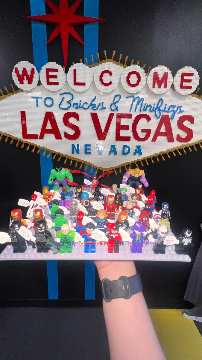 An assortment of LEGO® minifigures on a display board beneath the Las Vegas store sign.