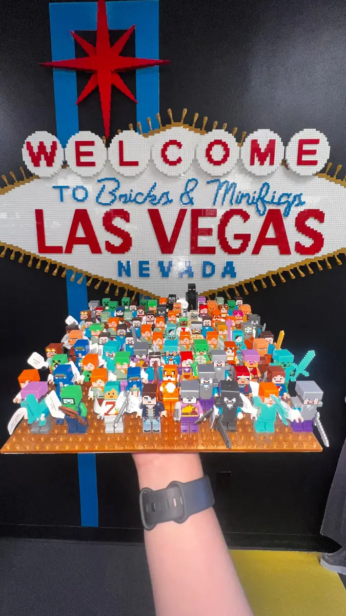 An assortment of LEGO® minifigures on a display board beneath the Las Vegas store sign.