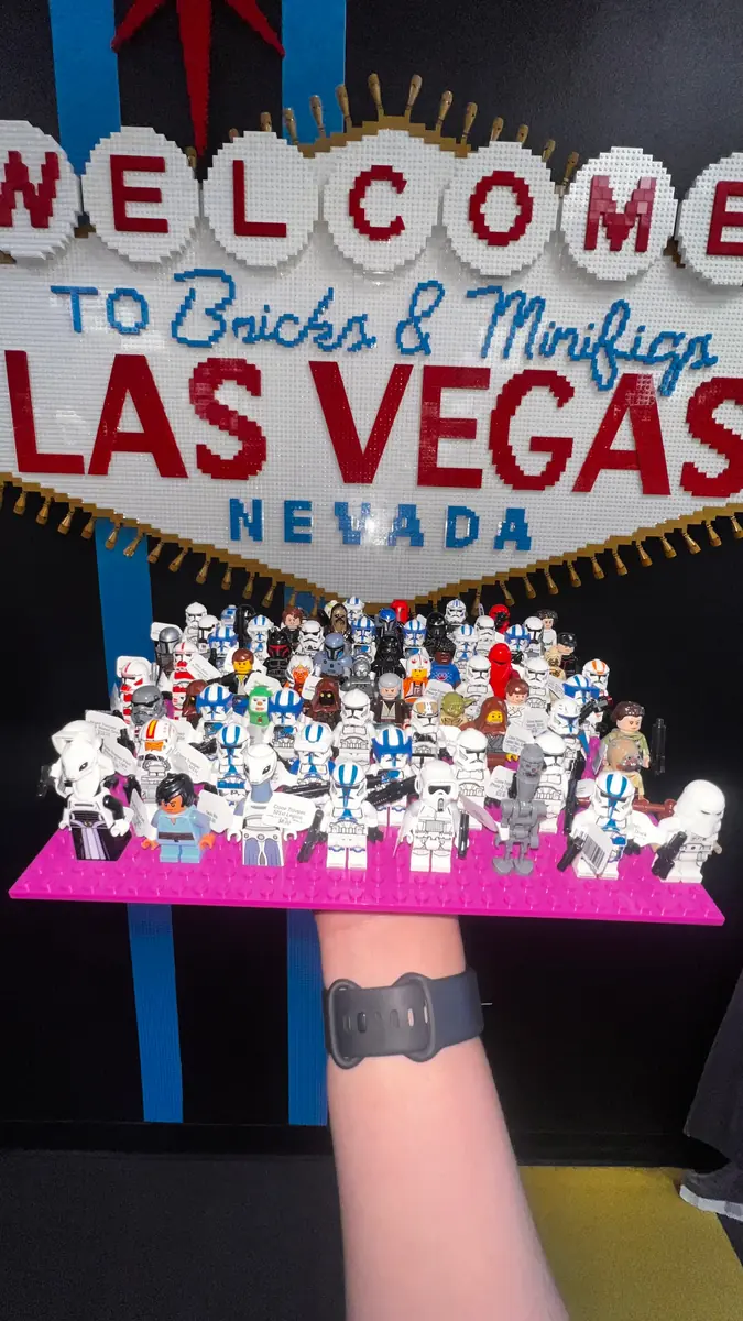 An assortment of LEGO® minifigures on a display board beneath the Las Vegas store sign.