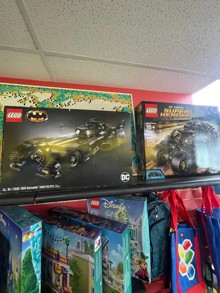 Boxed LEGO® Batman vehicles and other sets on store shelves in November 2025.