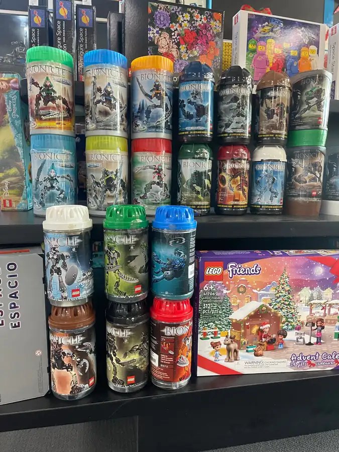 LEGO® BIONICLE canisters displayed beside boxed sets in November 2025.