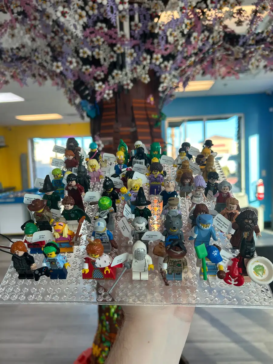 Rows of LEGO® minifigures on a hand-held display board at the Henderson store.