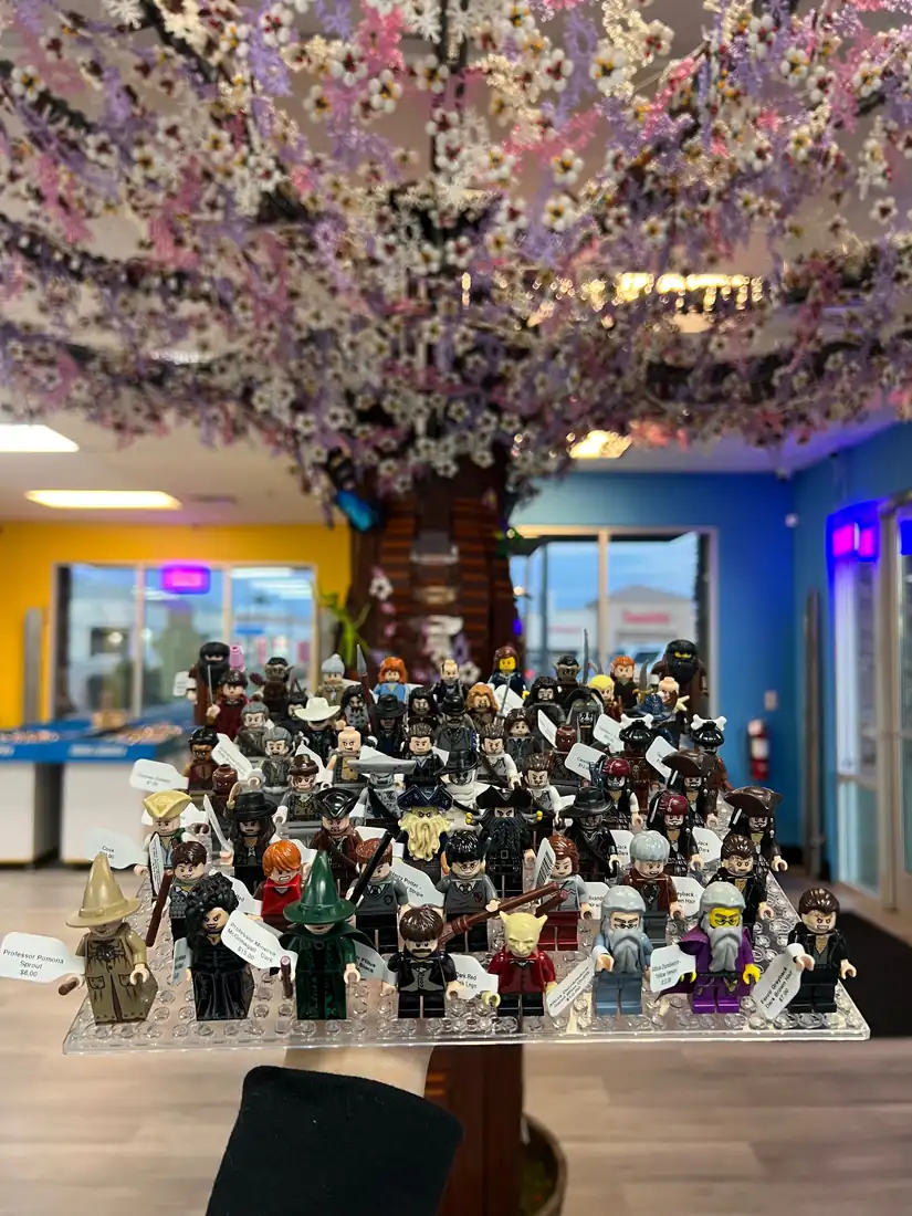 Rows of LEGO® minifigures on a hand-held display board at the Henderson store.