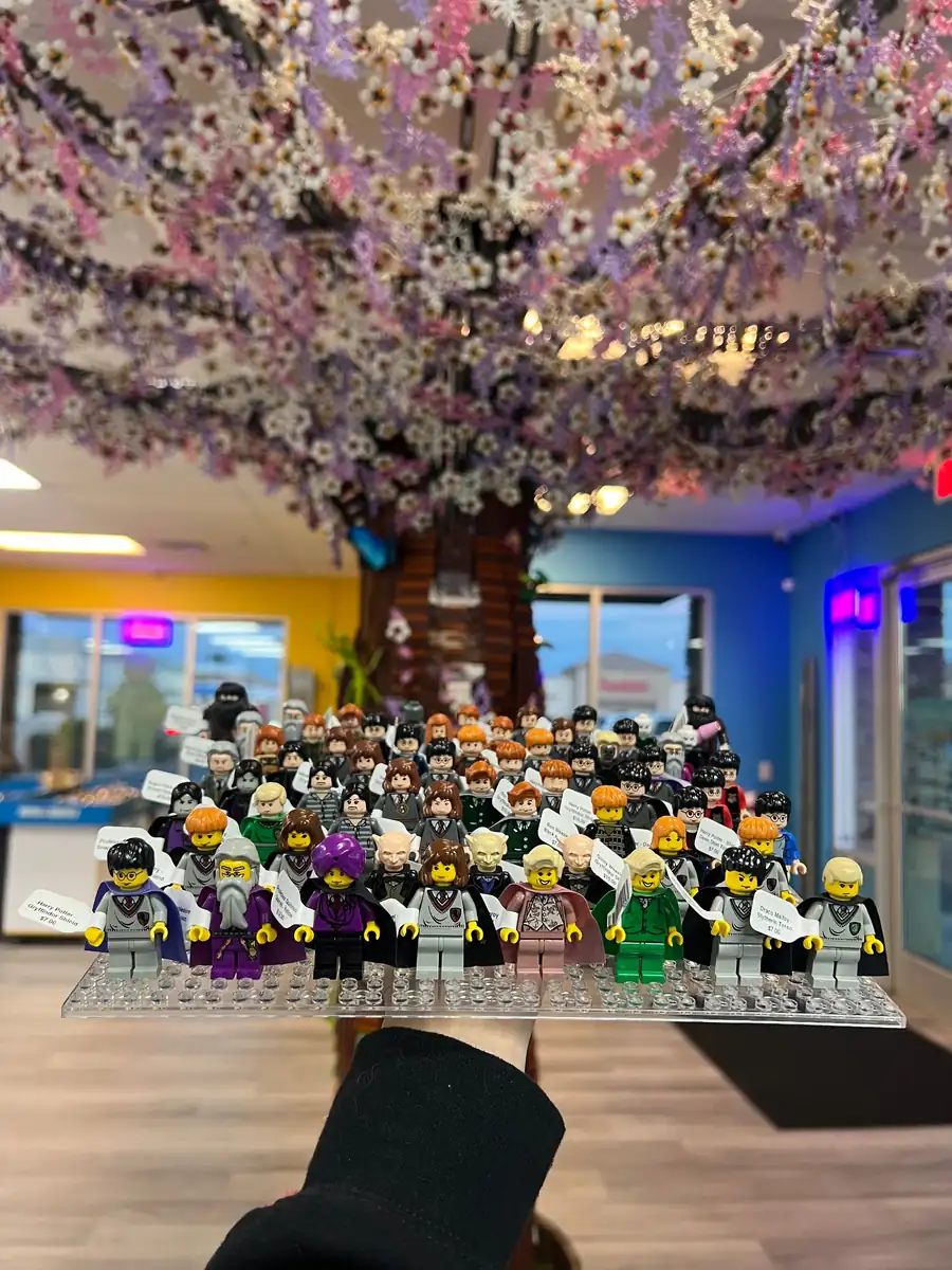 Rows of LEGO® minifigures on a hand-held display board at the Henderson store.