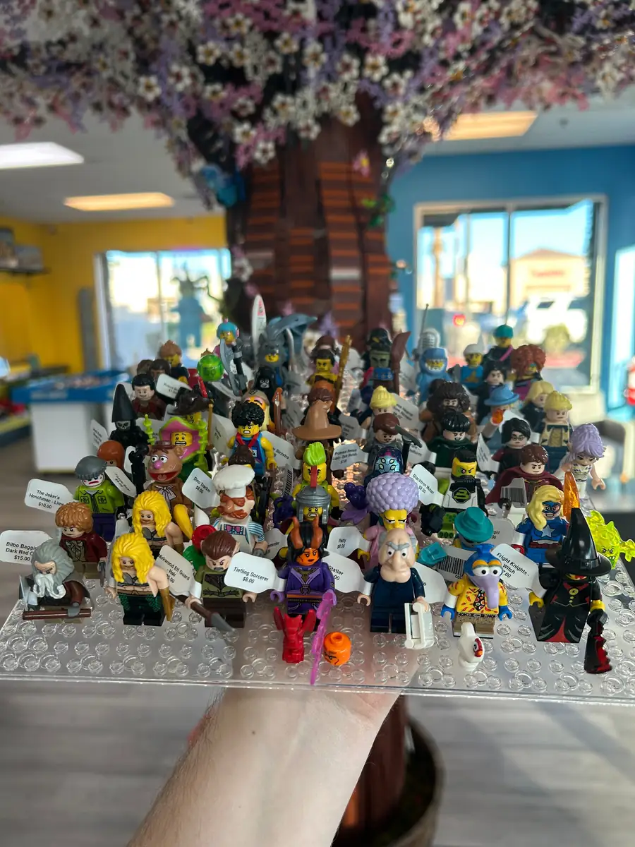 Rows of LEGO® minifigures on a hand-held display board at the Henderson store.