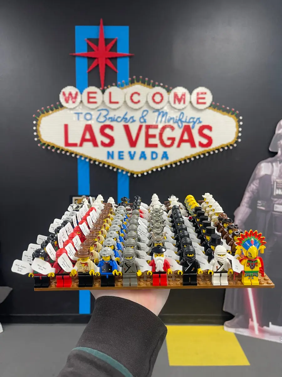 An assortment of LEGO® minifigures on a display board beneath the Las Vegas store sign.