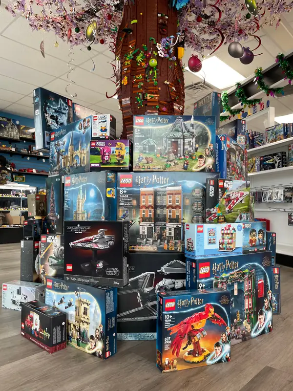 A wider view of the holiday LEGO® set display around the Henderson store tree.