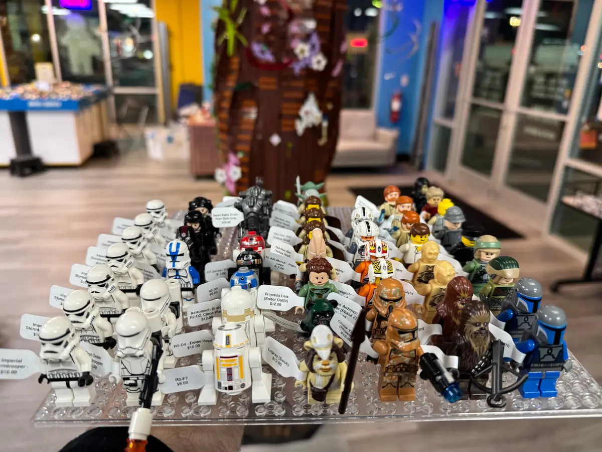 Rows of LEGO® minifigures on a hand-held display board at the Henderson store.