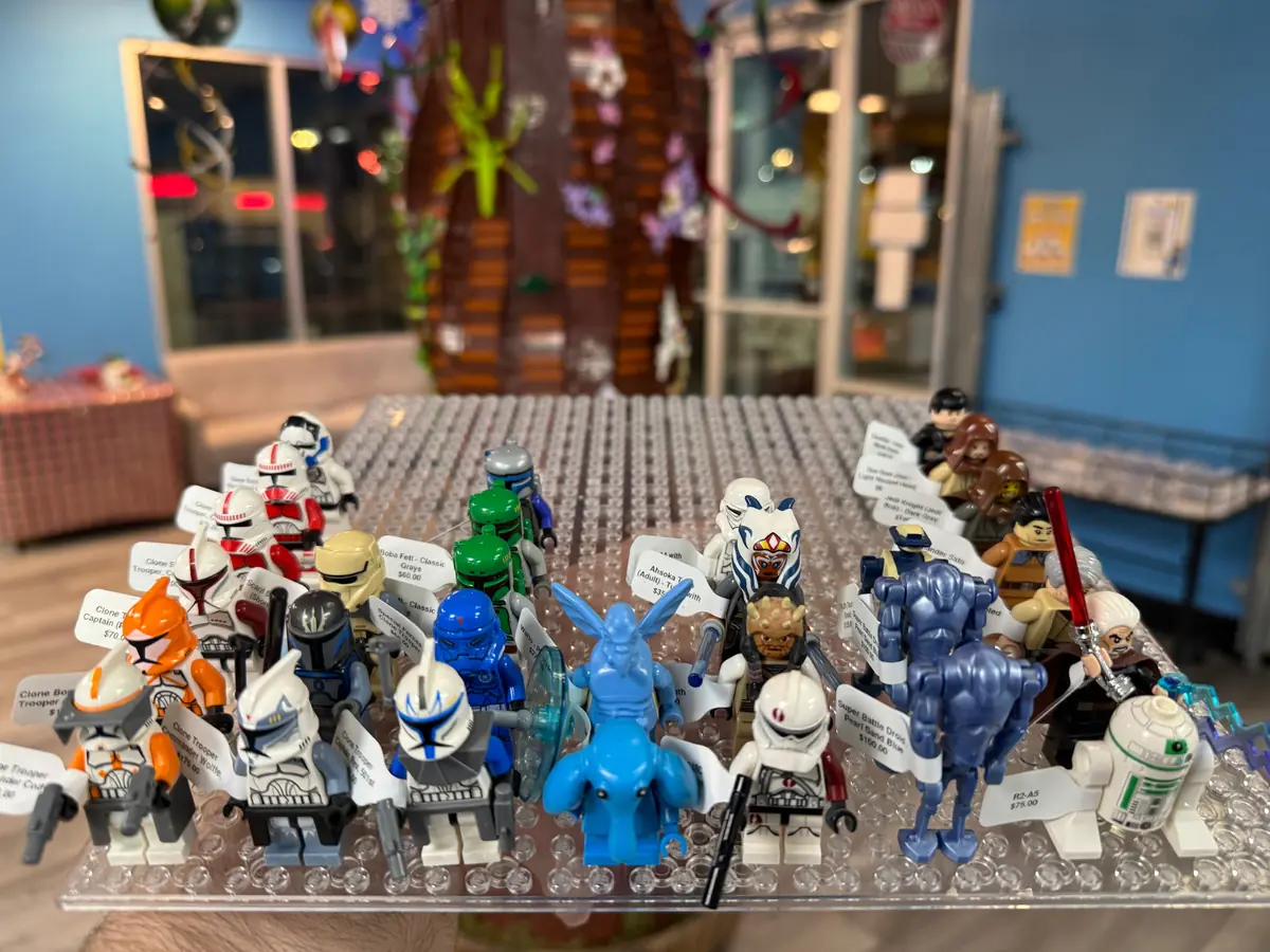 Rows of LEGO® minifigures on a hand-held display board at the Henderson store.