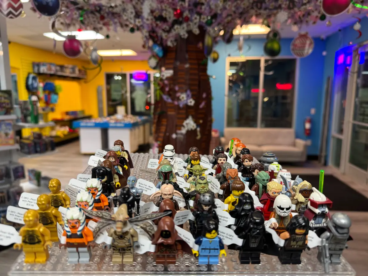 Rows of LEGO® minifigures on a hand-held display board at the Henderson store.