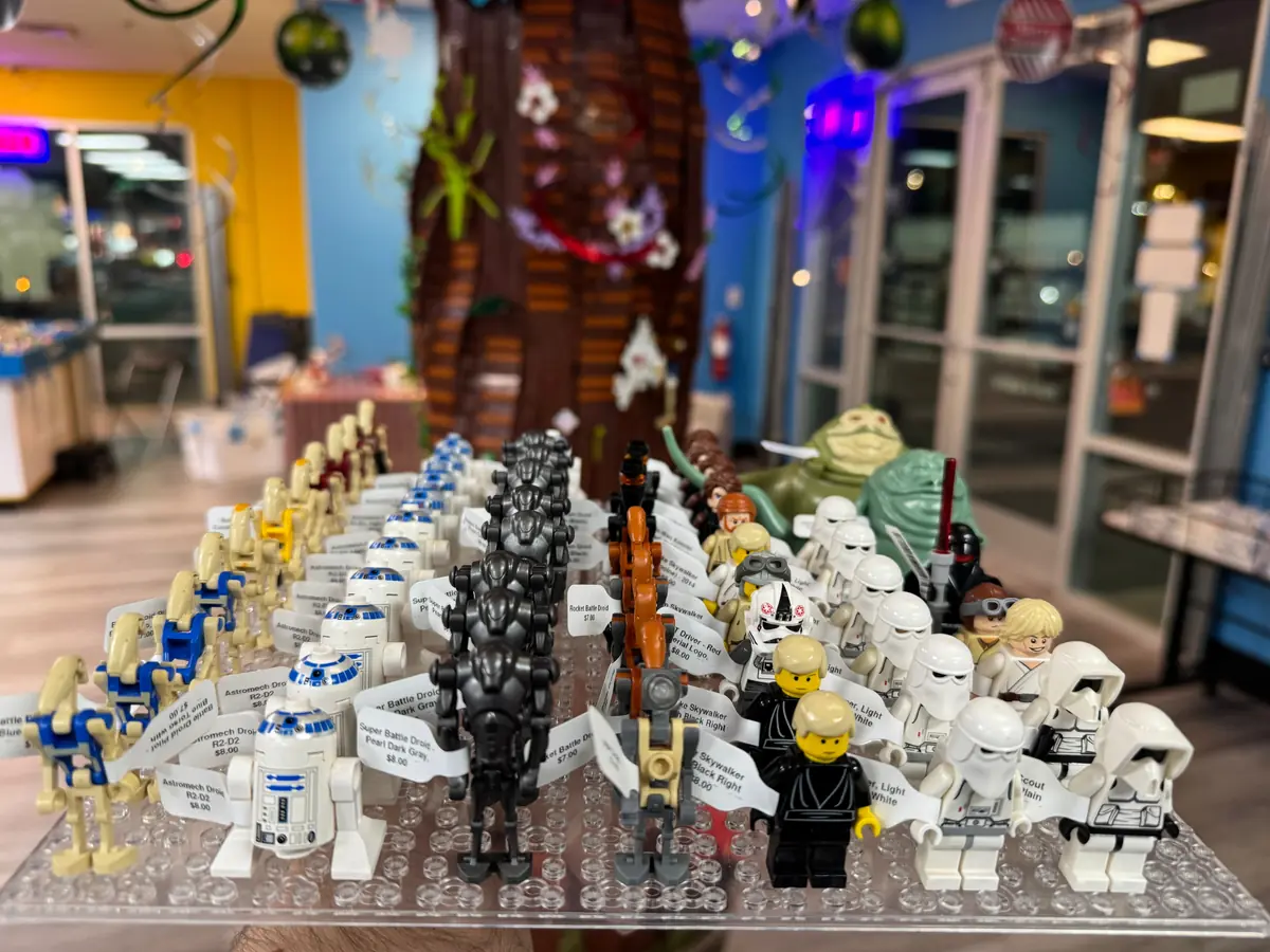 Rows of LEGO® minifigures on a hand-held display board at the Henderson store.