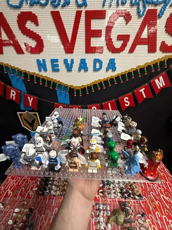 An assortment of LEGO® minifigures on a display board beneath the Las Vegas store sign.