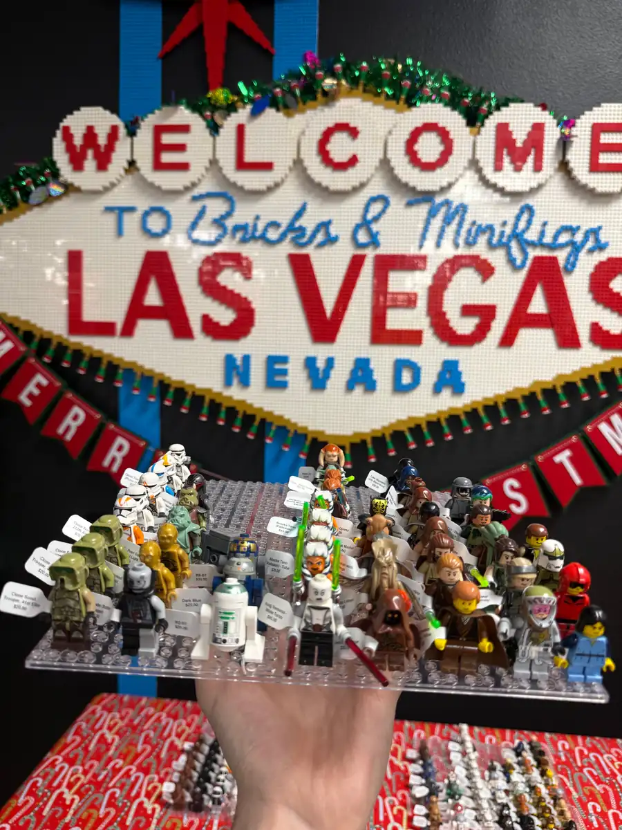 An assortment of LEGO® minifigures on a display board beneath the Las Vegas store sign.