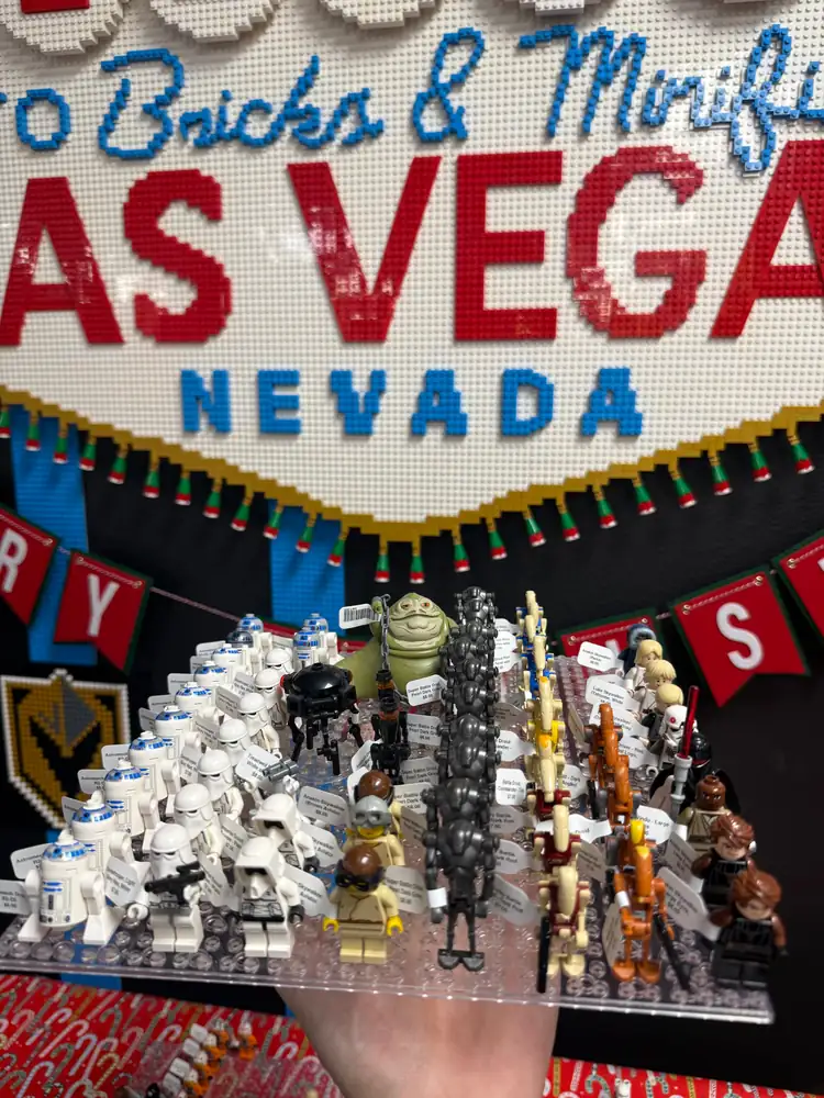 An assortment of LEGO® minifigures on a display board beneath the Las Vegas store sign.