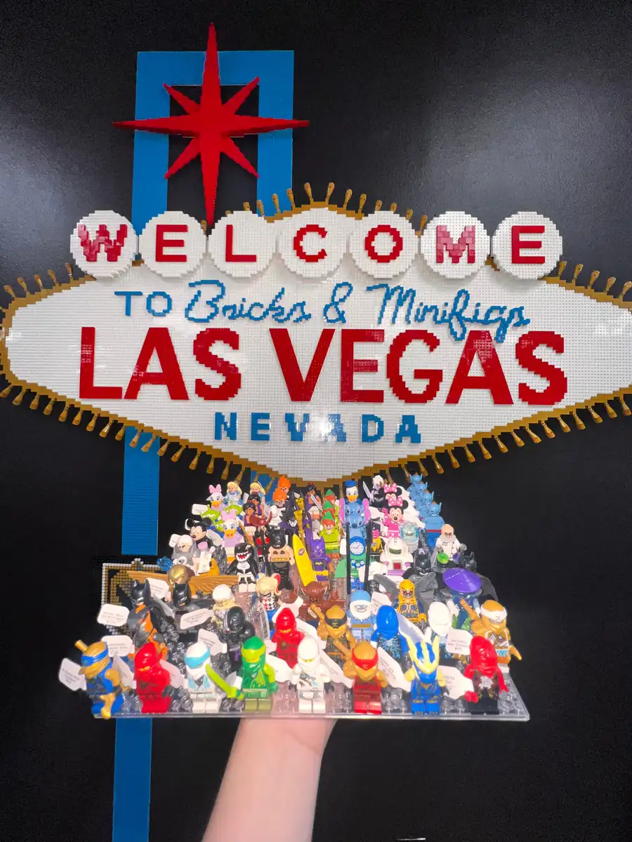 An assortment of LEGO® minifigures on a display board beneath the Las Vegas store sign.