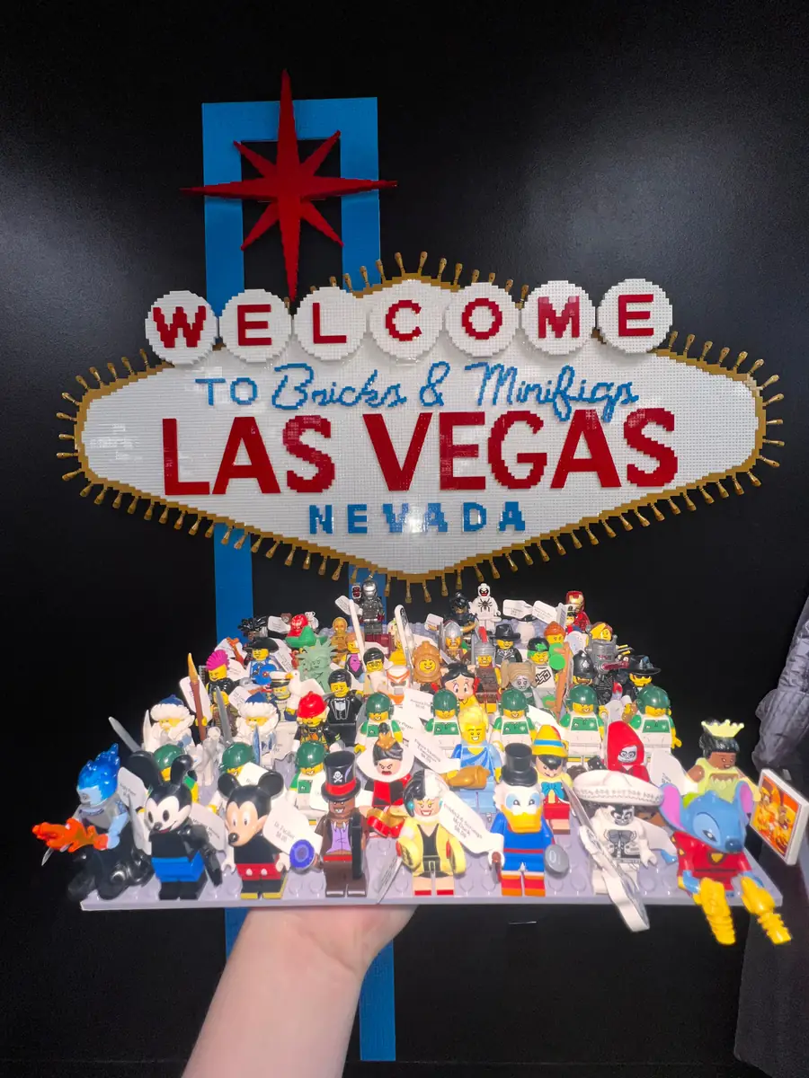 An assortment of LEGO® minifigures on a display board beneath the Las Vegas store sign.
