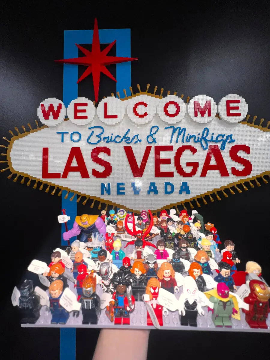 An assortment of LEGO® minifigures on a display board beneath the Las Vegas store sign.