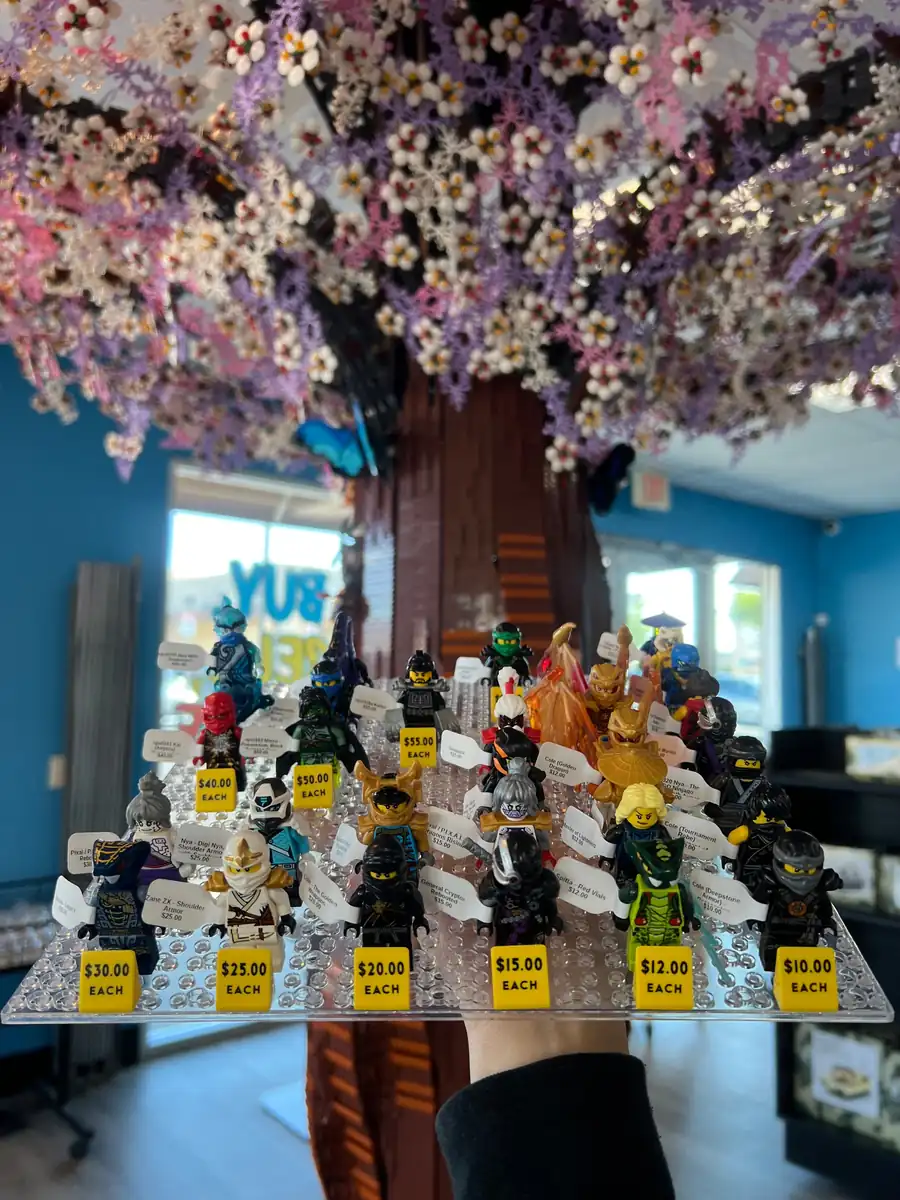 Rows of LEGO® minifigures on a hand-held display board at the Henderson store.