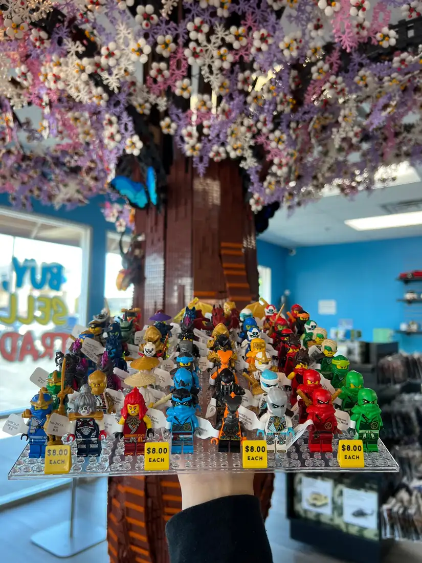 Rows of LEGO® minifigures on a hand-held display board at the Henderson store.