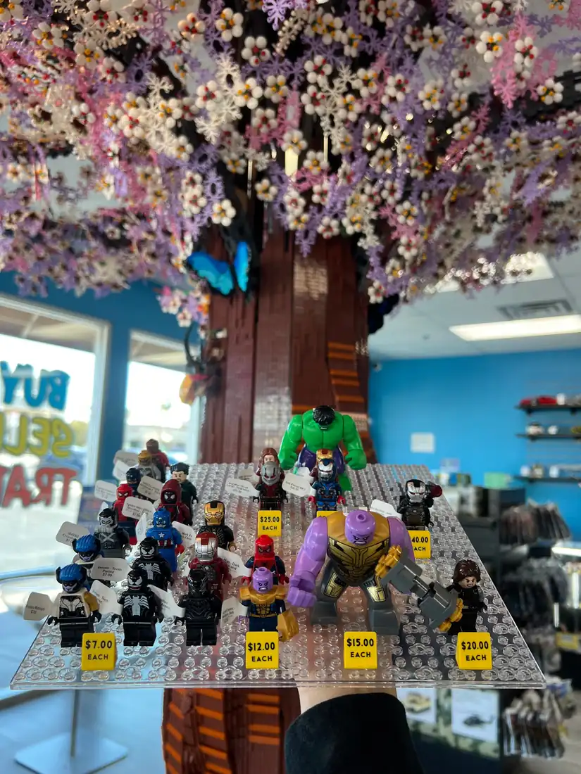 Rows of LEGO® minifigures on a hand-held display board at the Henderson store.