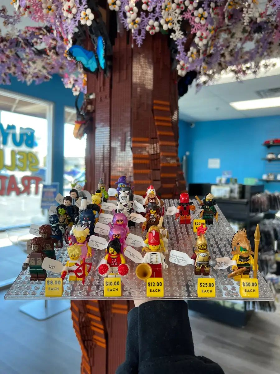 Rows of LEGO® minifigures on a hand-held display board at the Henderson store.