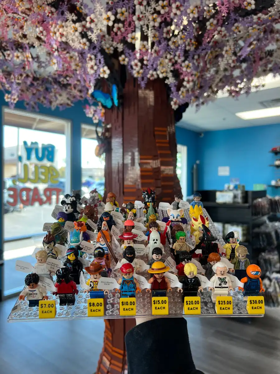 Rows of LEGO® minifigures on a hand-held display board at the Henderson store.