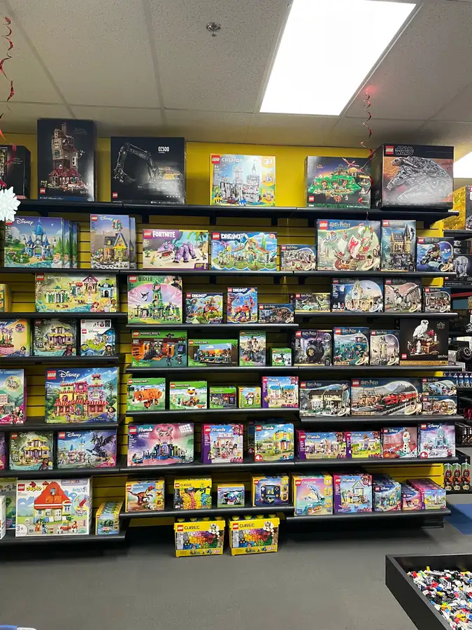 A wide display of boxed LEGO® sets on store shelving.
