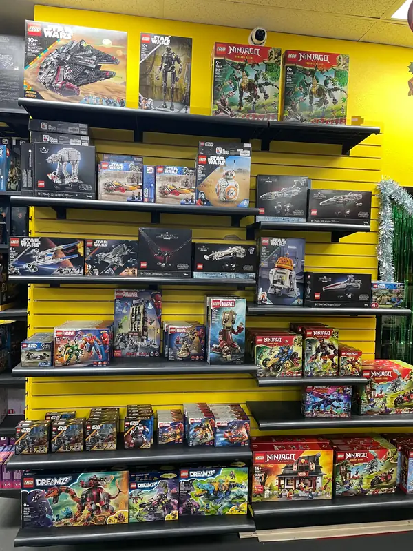 Another shelf display of boxed LEGO® vehicles and themed sets.