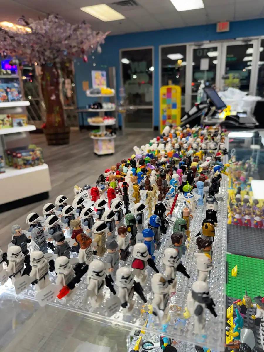 Rows of LEGO® minifigures on a hand-held display board at the Henderson store.