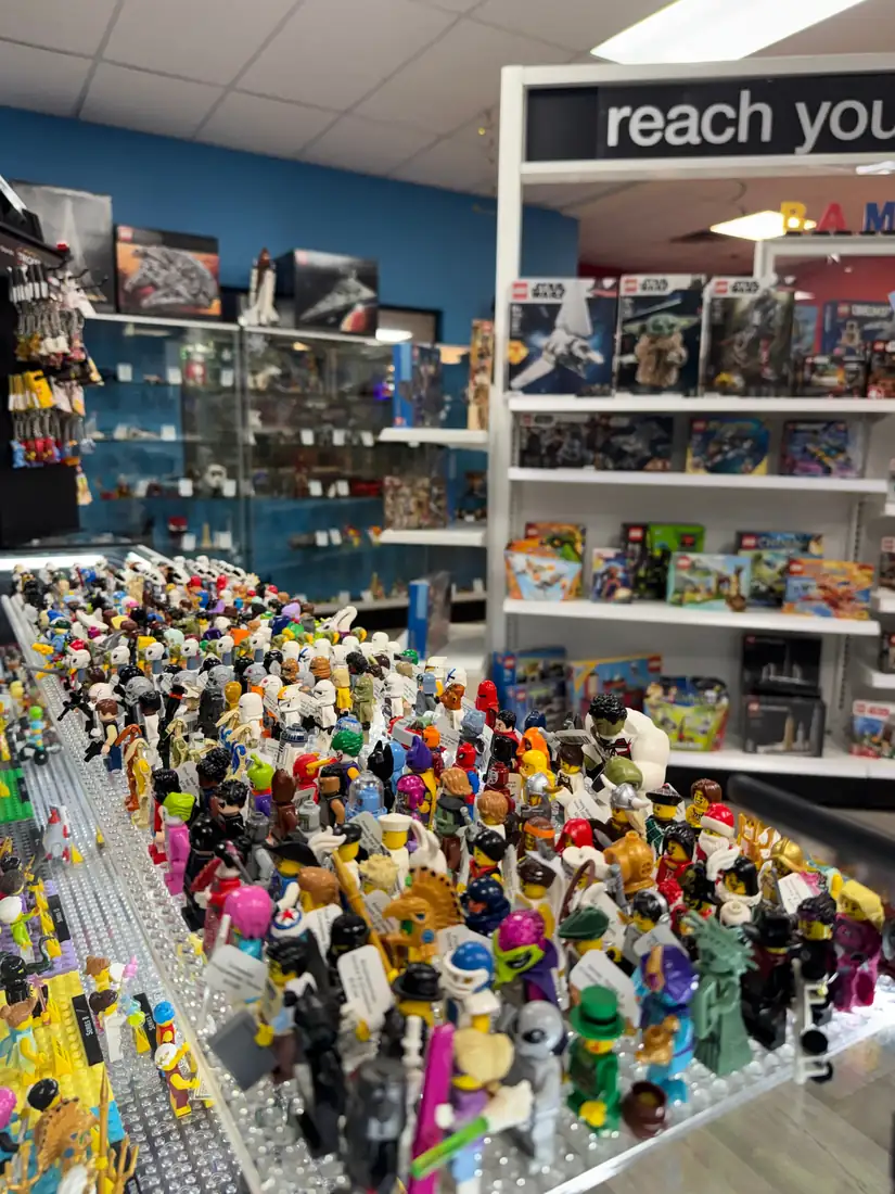 Rows of LEGO® minifigures on a hand-held display board at the Henderson store.