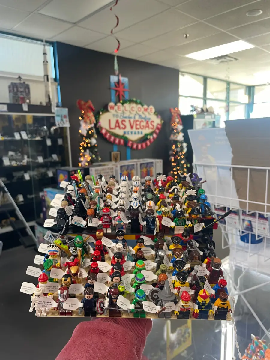 An assortment of LEGO® minifigures on a display board beneath the Las Vegas store sign.