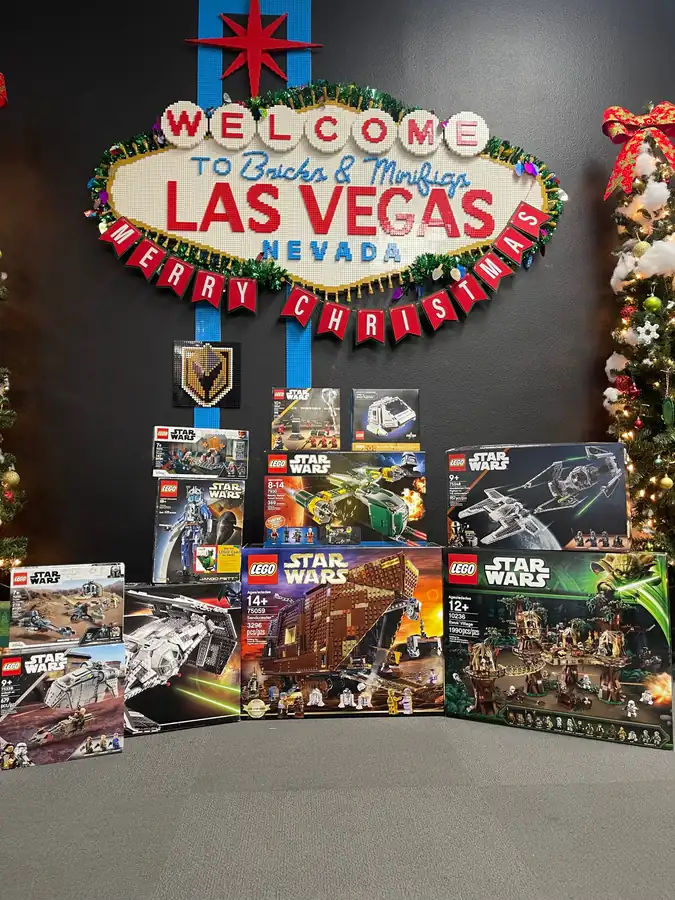 Boxed LEGO® Star Wars sets below the Las Vegas sign and holiday garland.