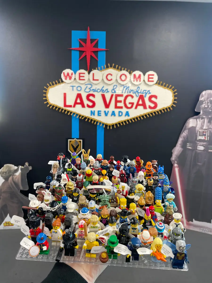 An assortment of LEGO® minifigures on a display board beneath the Las Vegas store sign.