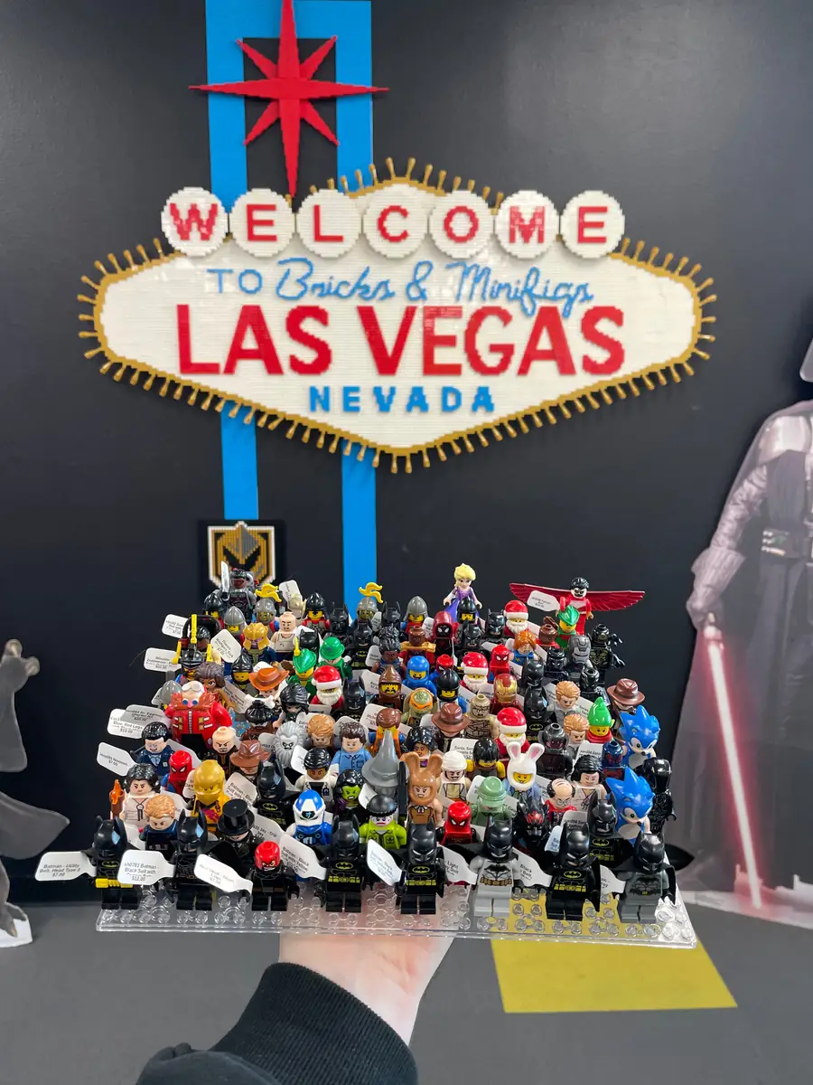 An assortment of LEGO® minifigures on a display board beneath the Las Vegas store sign.