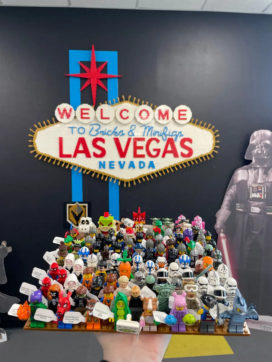An assortment of LEGO® minifigures on a display board beneath the Las Vegas store sign.