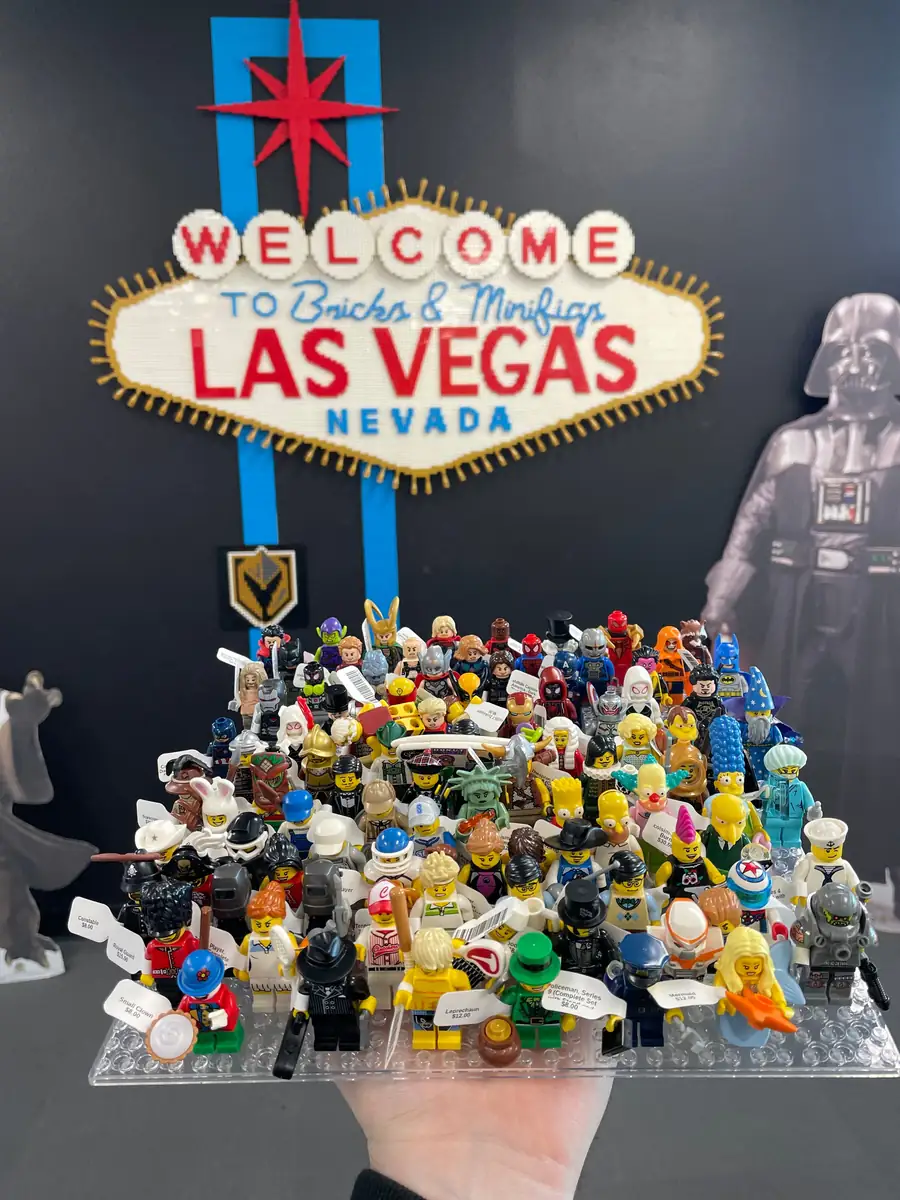 An assortment of LEGO® minifigures on a display board beneath the Las Vegas store sign.