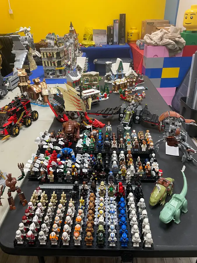 LEGO® minifigures and assembled models arranged on tables for a store restock.