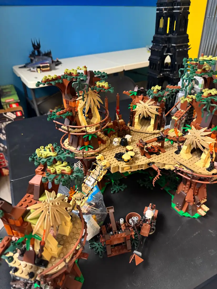 Detailed LEGO® buildings and colorful landscape models in a store display.