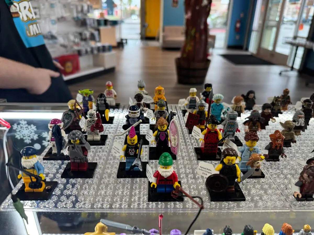Rows of LEGO® minifigures on a hand-held display board at the Henderson store.