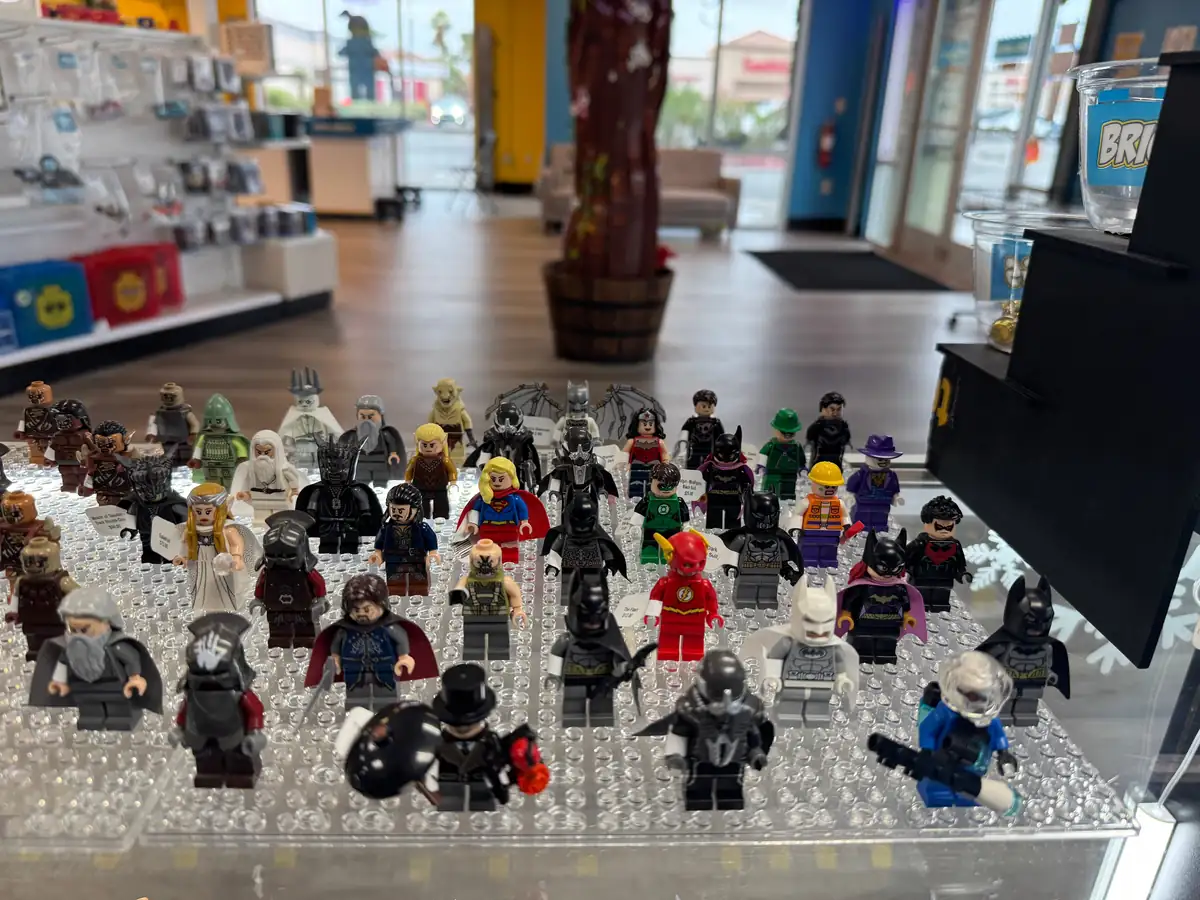 Rows of LEGO® minifigures on a hand-held display board at the Henderson store.