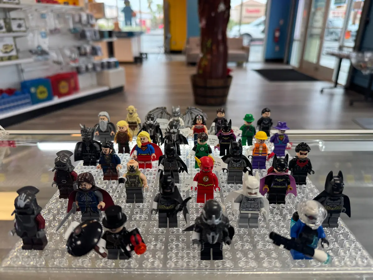 Rows of LEGO® minifigures on a hand-held display board at the Henderson store.