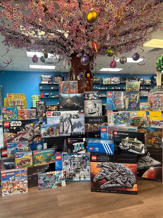 Boxed LEGO® sets stacked beneath the decorated Henderson tree for Black Friday.