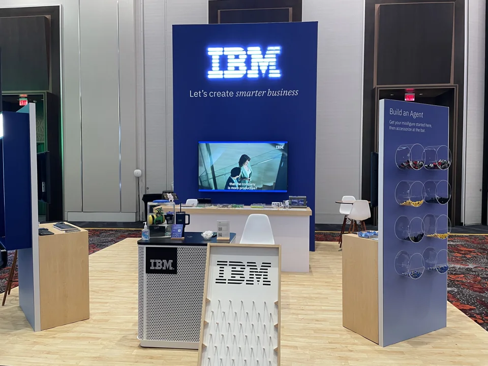 A building station and brick display at a convention booth.